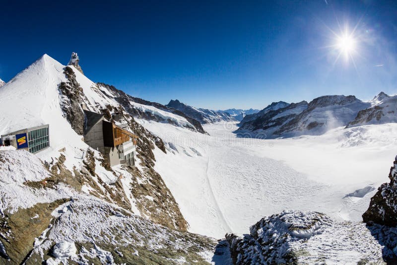 JUNGFRAUJOCH, SWITZERLAND - JANUARY 6, 2017: View to the Jungfraujoch observation station and Aletsch Glacier on January 6, 2017. Its the highest elevated point to reach by a cog railway in Europe. JUNGFRAUJOCH, SWITZERLAND - JANUARY 6, 2017: View to the Jungfraujoch observation station and Aletsch Glacier on January 6, 2017. Its the highest elevated point to reach by a cog railway in Europe.