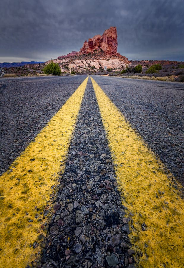 Road view towards a large monolith in Arches National Park, Utah. Road view towards a large monolith in Arches National Park, Utah