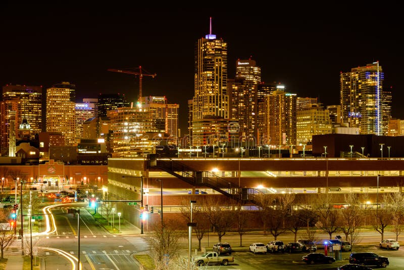 Denver, Colorado, USA - December 09, 2015: A night view of glittering skyscrapers and bright streets of Downtown Denver, near Metropolitan State University of Denver. Denver, Colorado, USA - December 09, 2015: A night view of glittering skyscrapers and bright streets of Downtown Denver, near Metropolitan State University of Denver.