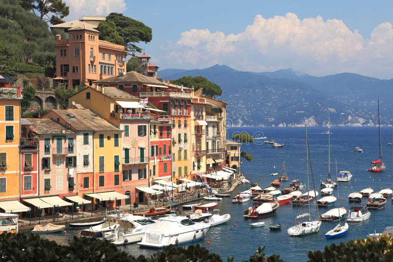 View on famous town of Portofino with small bay full of yachts and boats on Ligurian sea, northern Italy. View on famous town of Portofino with small bay full of yachts and boats on Ligurian sea, northern Italy.