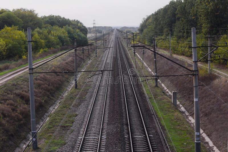 Railway, view from the top. The rails go into the distance beyond the horizon. Two pairs of railways run straight. High quality photo. Railway, view from the top. The rails go into the distance beyond the horizon. Two pairs of railways run straight. High quality photo