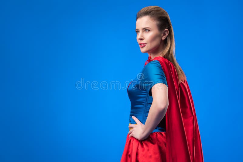 vista lateral de la mujer hermosa en la situación del traje del super héroe en jarras