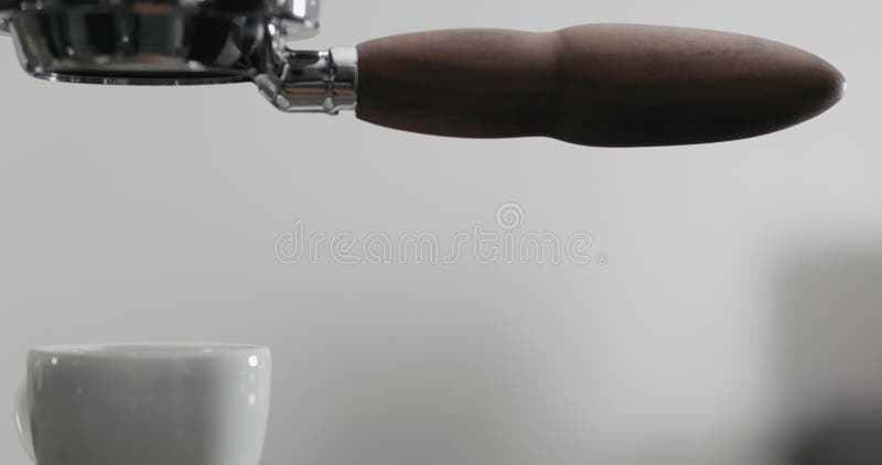 Vista laterale in slow motion dell'estrazione dell'espresso con portafiltro senza fondo