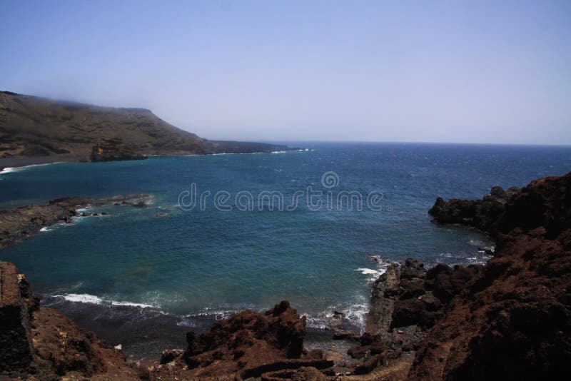 Vista na lagoa isolado cercada por penhascos resistidos ásperos impressionantes em cores diferentes - EL Golfo, Lanzarote fotos de stock royalty free Vista na lagoa isolado cercada por penhascos resistidos ásperos impressionantes em cores diferentes - EL Golfo, Lanzarote fotos de stock royalty free