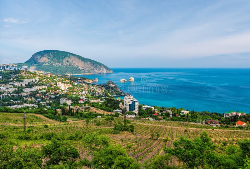 Panoramic view on city Gurzuf and Bear Mountain, Au-Dag, Crimea. Sunny day. The concept of active city in unity with nature. Panoramic view on city Gurzuf and Bear Mountain, Au-Dag, Crimea. Sunny day. The concept of active city in unity with nature