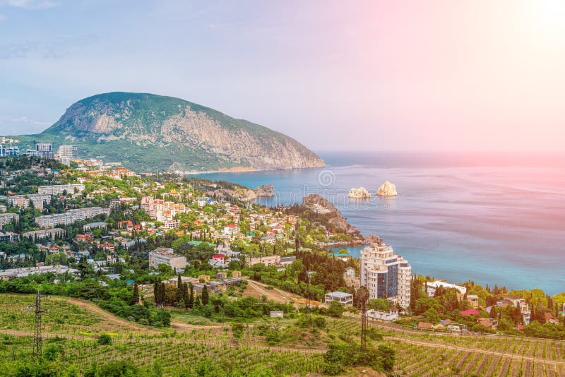 Panoramic view on city Gurzuf and Bear Mountain, Au-Dag, Crimea. Sunny day. The concept of active city in unity with nature. Panoramic view on city Gurzuf and Bear Mountain, Au-Dag, Crimea. Sunny day. The concept of active city in unity with nature