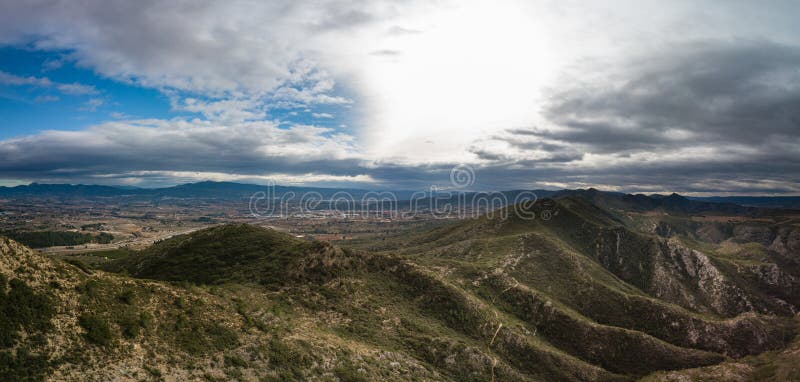 Vista panorâmica das montanhas com os canais do céu dramático e da cidade pequena, Espanha no fundo fotografia de stock royalty free Vista panorâmica das montanhas com os canais do céu dramático e da cidade pequena, Espanha no fundo fotografia de stock royalty free