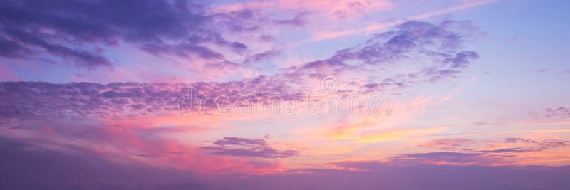 Panoramic view of a pink and purple sky at sunset. Panoramic view of a pink and purple sky at sunset