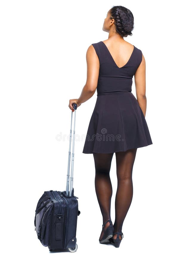 Vista posterior de una mujer negra elegante con una maleta mirando hacia arriba imagenes de archivo Vista posterior de una mujer negra elegante con una maleta mirando hacia arriba imagenes de archivo