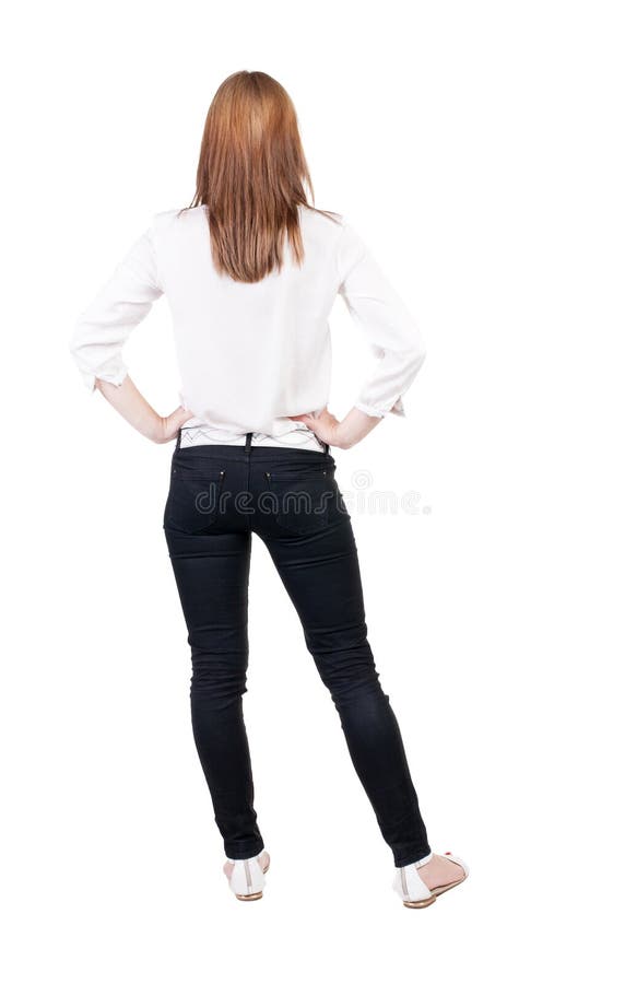 Vista posteriore di stare giovane bella donna bionda in jeans fotografia stock Vista posteriore di stare giovane bella donna bionda in jeans fotografia stock