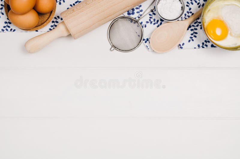 Baking a cake or pizza ingredients background. Top view photograph with kitchen utensils on vintage, natural, white, wooden background. Baking a cake or pizza ingredients background. Top view photograph with kitchen utensils on vintage, natural, white, wooden background.