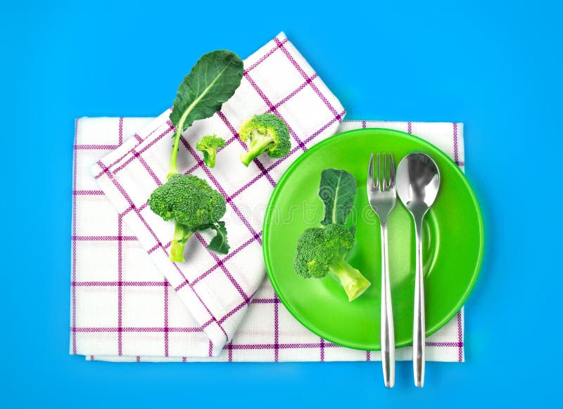 Vista superiore dei broccoli freschi in piatto ed asciugamano verdi sul co vibrante immagini stock libere da diritti Vista superiore dei broccoli freschi in piatto ed asciugamano verdi sul co vibrante immagini stock libere da diritti