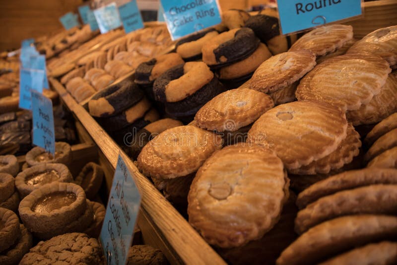 Newcastle / Great Britain - December 14, 2019 : Sweet confectionary stand stall vendor displaying patisseries and donuts for sale. Newcastle / Great Britain - December 14, 2019 : Sweet confectionary stand stall vendor displaying patisseries and donuts for sale