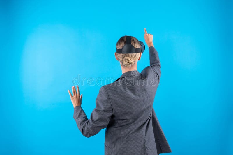 Back view of caucasian executive manager pointing and manage data analysis. Investor with VR glasses looking at financial data and making decision for investment. Technology innovation. Contraption. Back view of caucasian executive manager pointing and manage data analysis. Investor with VR glasses looking at financial data and making decision for investment. Technology innovation. Contraption.