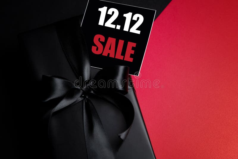 Top view of black gift box with black background with copy space for text 12.12 singles day sale. Online shopping of China, 12.12 singles day sale concept. Top view of black gift box with black background with copy space for text 12.12 singles day sale. Online shopping of China, 12.12 singles day sale concept