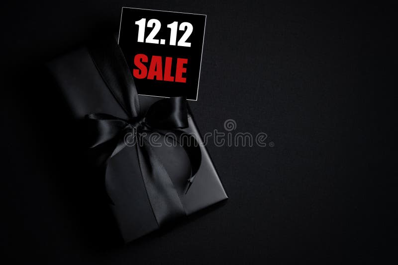 Top view of black gift box with black background with copy space for text 12.12 singles day sale. Online shopping of China, 12.12 singles day sale concept. Top view of black gift box with black background with copy space for text 12.12 singles day sale. Online shopping of China, 12.12 singles day sale concept