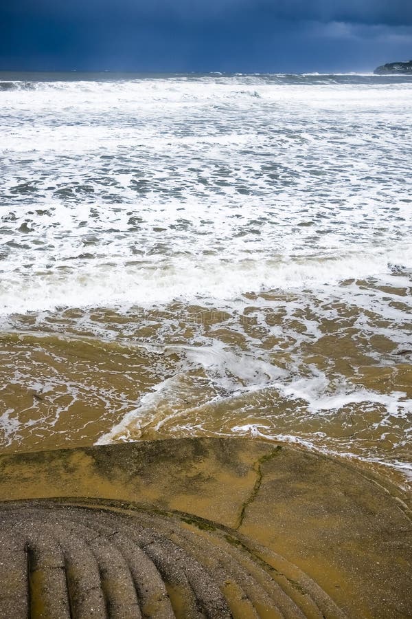 White splash of waves on San Lorenzo beach, Gijon Asturias, duing a rainstorm. White splash of waves on San Lorenzo beach, Gijon Asturias, duing a rainstorm