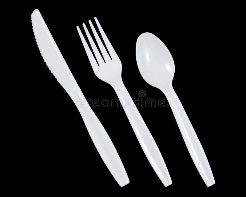 Vit plast- kniv, gaffel och sked på svart bakgrund royaltyfri bild Vit plast- kniv, gaffel och sked på svart bakgrund royaltyfri bild