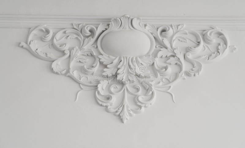 White wall molding with geometric shape and vanishing point. Luxury white wall design bas-relief with stucco mouldings roccoco element. White wall molding with geometric shape and vanishing point. Luxury white wall design bas-relief with stucco mouldings roccoco element.