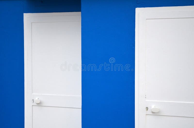 2 white doors in a blue wall. 2 white doors in a blue wall