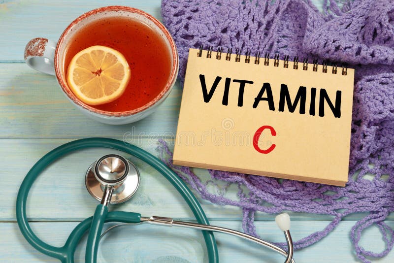 VITAMIN C lettering. Hot tea, knitted scarf and stethoscope