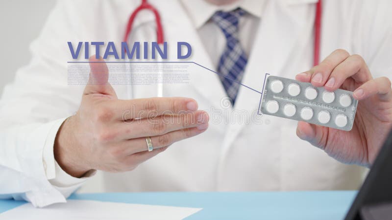 Vitamin d blister pack with tablets in doctor`s hand