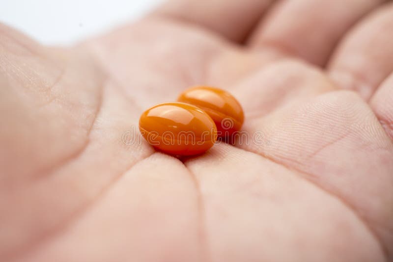 Vitamin Rice Bran Oil , Orange pills on hand