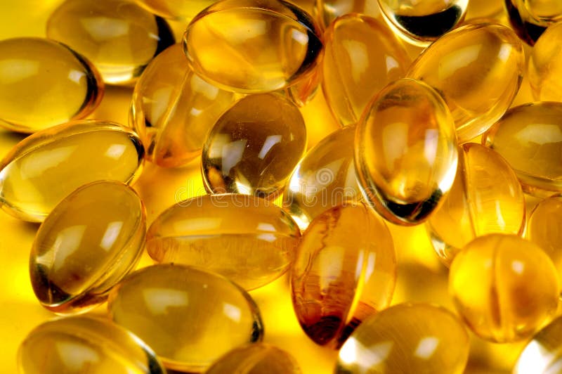 A view with some vitamins over yellow background. A view with some vitamins over yellow background