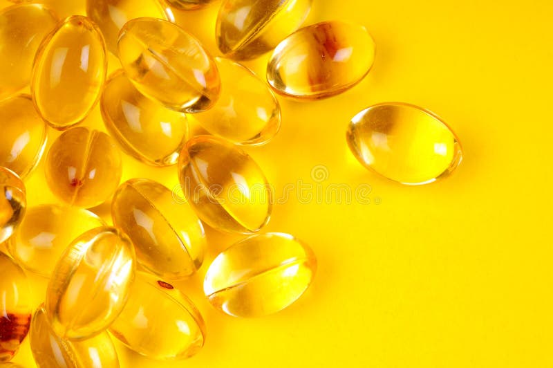 A view with some vitamins over yellow background. A view with some vitamins over yellow background