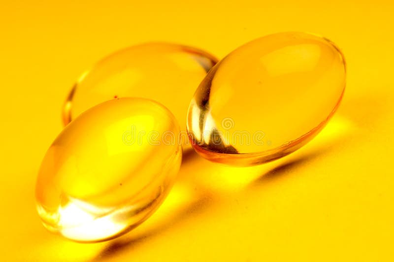 A view with some vitamins over yellow background. A view with some vitamins over yellow background