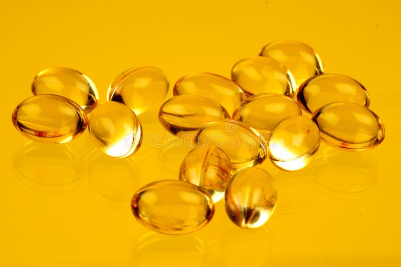 A view with some vitamins over yellow background. A view with some vitamins over yellow background