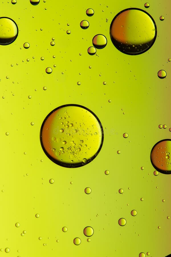 Vivid yellow oil and water abstract background stock photos