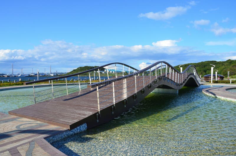 Vladivostok, Russia, September, 14, 2017. Wooden bridge in the park on the territory of he Oceanarium on the island Russkiy in Vl stock photo Vladivostok, Russia, September, 14, 2017. Wooden bridge in the park on the territory of he Oceanarium on the island Russkiy in Vl stock photo