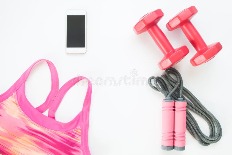 Vlak leg van cellphone met roze sportbustehouder, Springtouw stock afbeeldingen Vlak leg van cellphone met roze sportbustehouder, Springtouw stock afbeeldingen