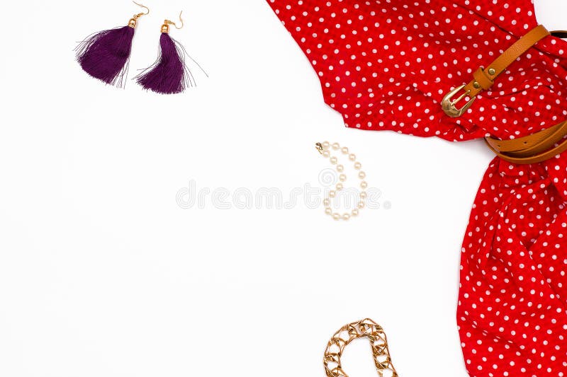 Flat lay feminine clothes and accessories on white background. red dress, earrings, pearl bracelet. Top view. Flat lay feminine clothes and accessories on white background. red dress, earrings, pearl bracelet. Top view.