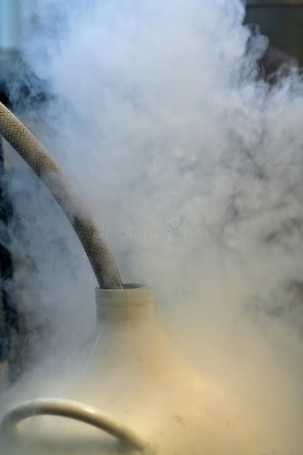 Liquid nitrogen decanted into cryogenic dewar. Liquid nitrogen decanted into cryogenic dewar