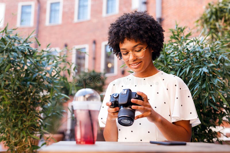 Vlogger novo que senta-se no café exterior fotografia de stock Vlogger novo que senta-se no café exterior fotografia de stock