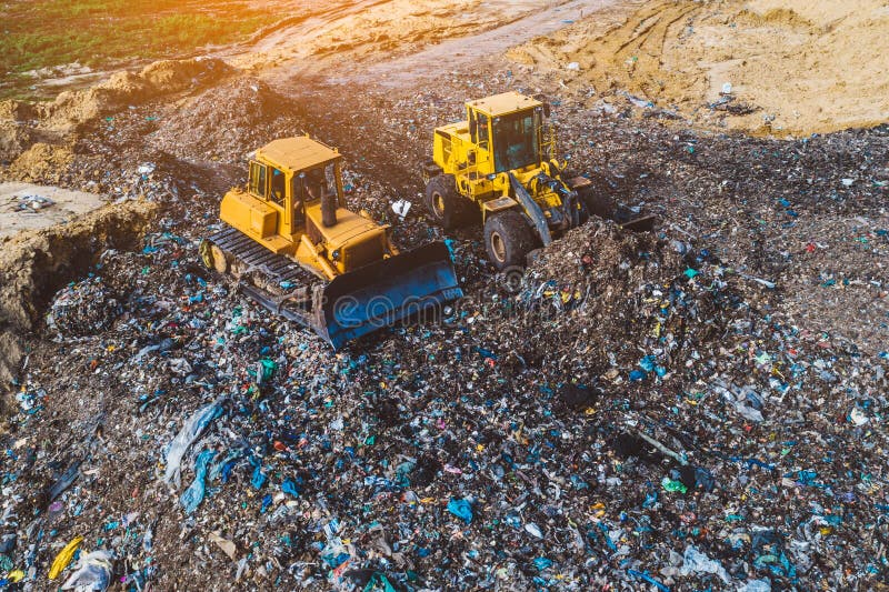 Aerial view on bulldozers working on the landfill. Environmental pollution. Aerial view on bulldozers working on the landfill. Environmental pollution