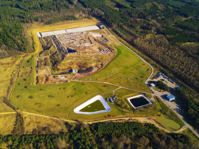 Aerial view of municipal landfill site. Typical waste treatment technology top view. Garbage pile and toxic lakes with dangerous chemicals in trash dump. Aerial view of municipal landfill site. Typical waste treatment technology top view. Garbage pile and toxic lakes with dangerous chemicals in trash dump.