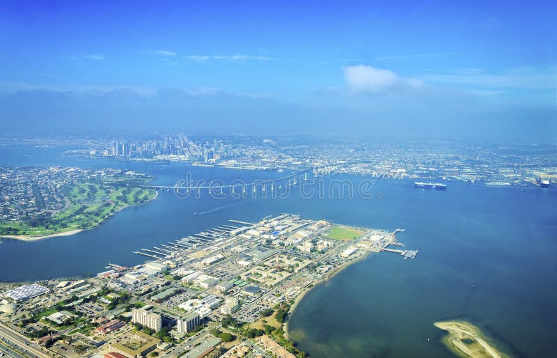 Aerial view of the Coronado island and bridge in the San Diego Bay in Southern California, United States of America. A view of the Skyline of the city and some boats crossing the the sea. Aerial view of the Coronado island and bridge in the San Diego Bay in Southern California, United States of America. A view of the Skyline of the city and some boats crossing the the sea.