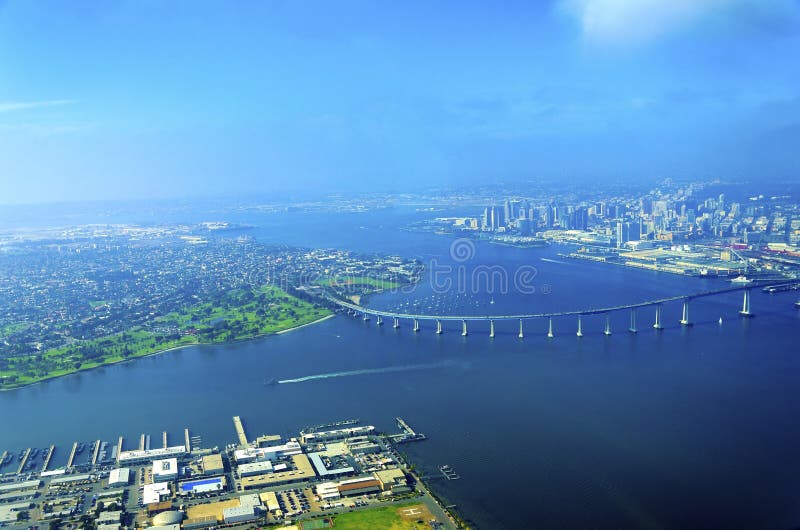 Aerial view of the Coronado island and bridge in the San Diego Bay in Southern California, United States of America. A view of the Skyline of the city and some boats crossing the the sea. Aerial view of the Coronado island and bridge in the San Diego Bay in Southern California, United States of America. A view of the Skyline of the city and some boats crossing the the sea.