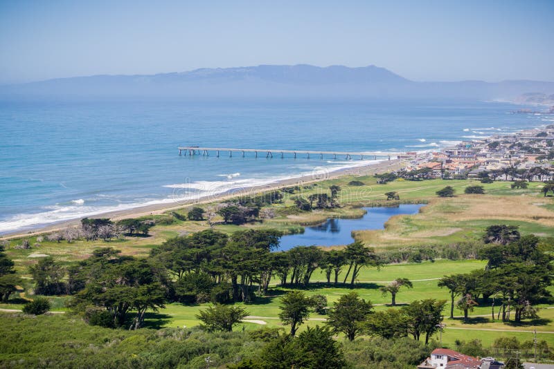 Aerial view of Pacifica Municipal Pier and Sharp Park golf course as seen from the top of Mori Point, Marin County in the background, California. Aerial view of Pacifica Municipal Pier and Sharp Park golf course as seen from the top of Mori Point, Marin County in the background, California