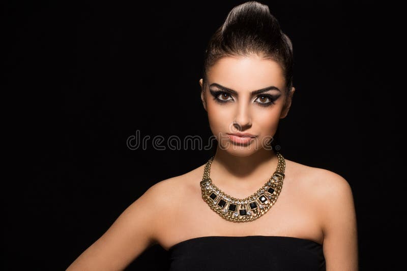 Vogue. Beautiful woman posing in black dress