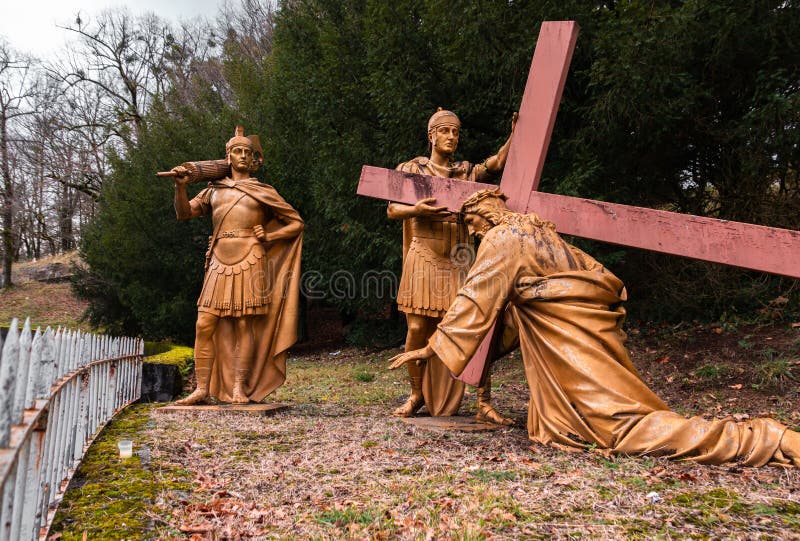 Lourdes, France - January 5, 2022: Way of the cross of Lourdes - third station: Jesus falls a first time under the cross. Lourdes, France - January 5, 2022: Way of the cross of Lourdes - third station: Jesus falls a first time under the cross