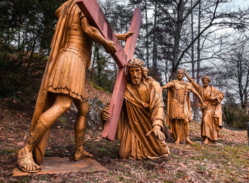 Lourdes, France - January 5, 2022: Way of the cross of Lourdes - third station: Jesus falls a first time under the cross. Lourdes, France - January 5, 2022: Way of the cross of Lourdes - third station: Jesus falls a first time under the cross