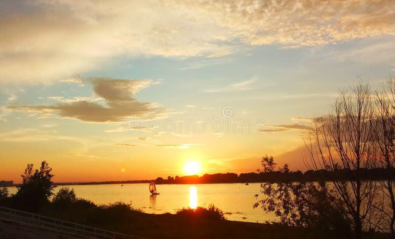 voilier isolé sur la rivière contre le coucher de soleil photographie stock libre de droits voilier isolé sur la rivière contre le coucher de soleil photographie stock libre de droits