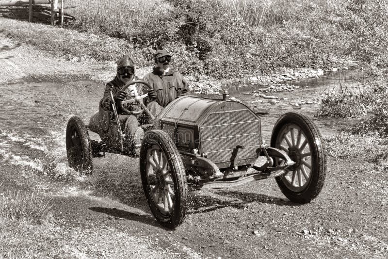 Voiture ancienne emballant sur le vieux chemin de terre image libre de droits Voiture ancienne emballant sur le vieux chemin de terre image libre de droits