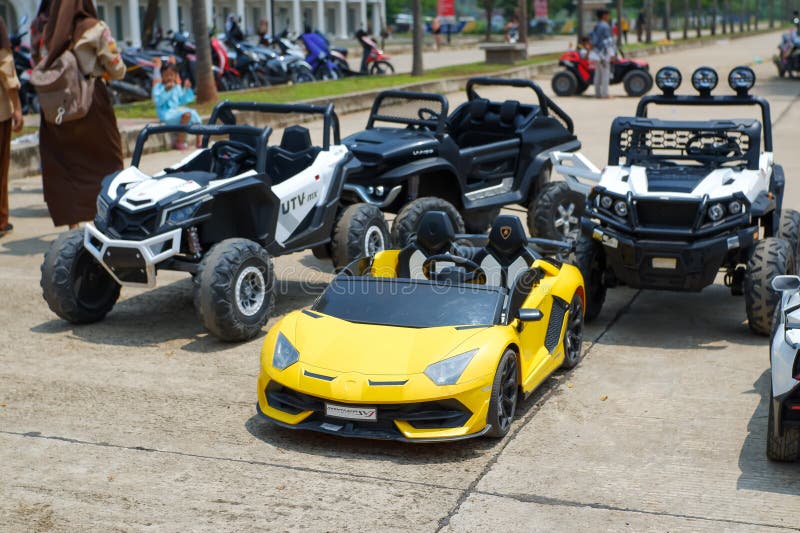 Plastic Ferraris and Jeeps for small children's toys are displayed in children's playgrounds. Plastic Ferraris and Jeeps for small children's toys are displayed in children's playgrounds