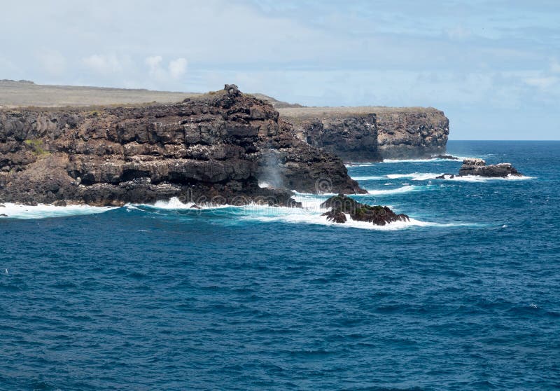 Volcanic rock lines coast in Galapagos