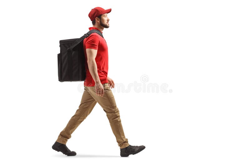 Full length profile shot of a food delivery guy walking with a bag isolated on white background. Full length profile shot of a food delivery guy walking with a bag isolated on white background